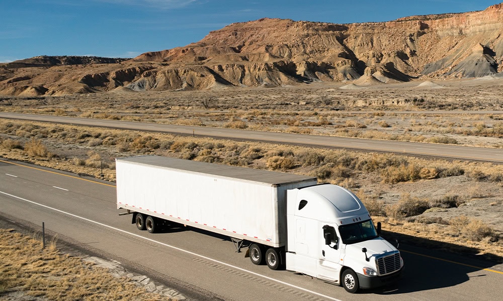 A white semi-truck on a road